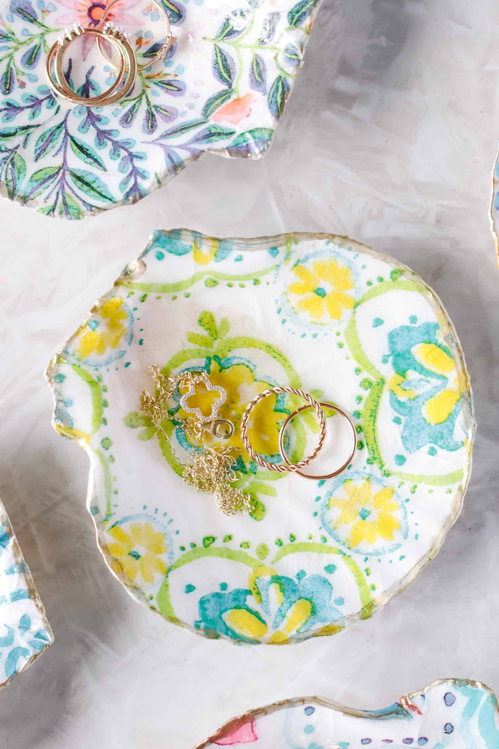 Decorated shell ring dish with gold rings.