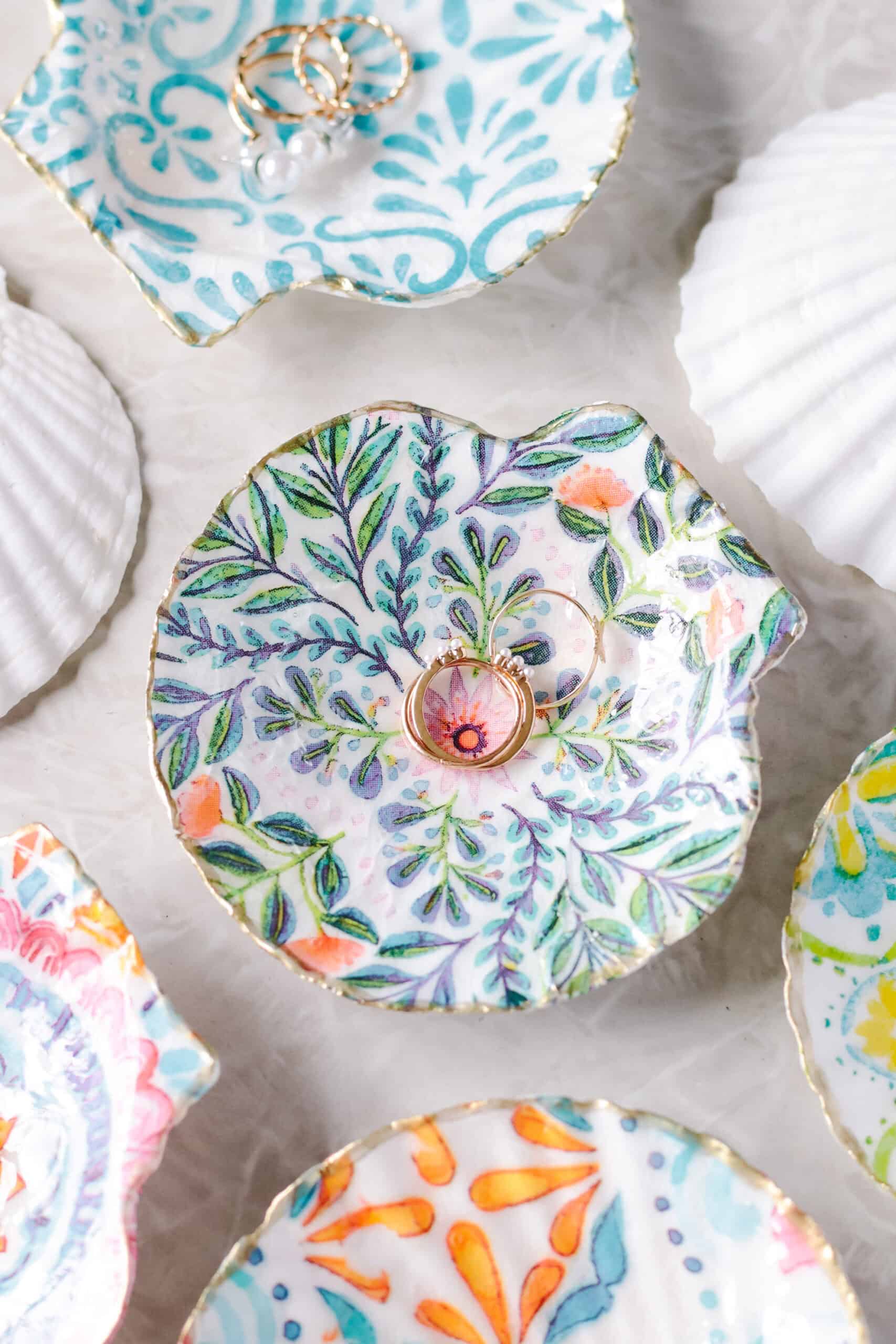 Decorated ring dishes with earrings and rings.