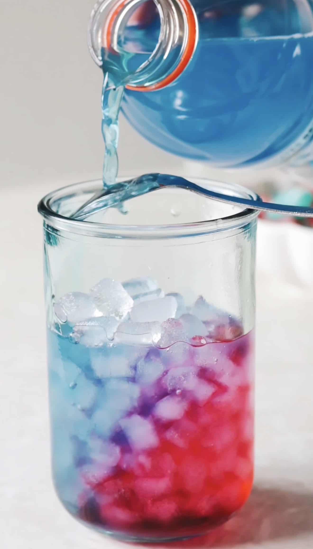 Blue Gatorade poured over the red layer in the punch.