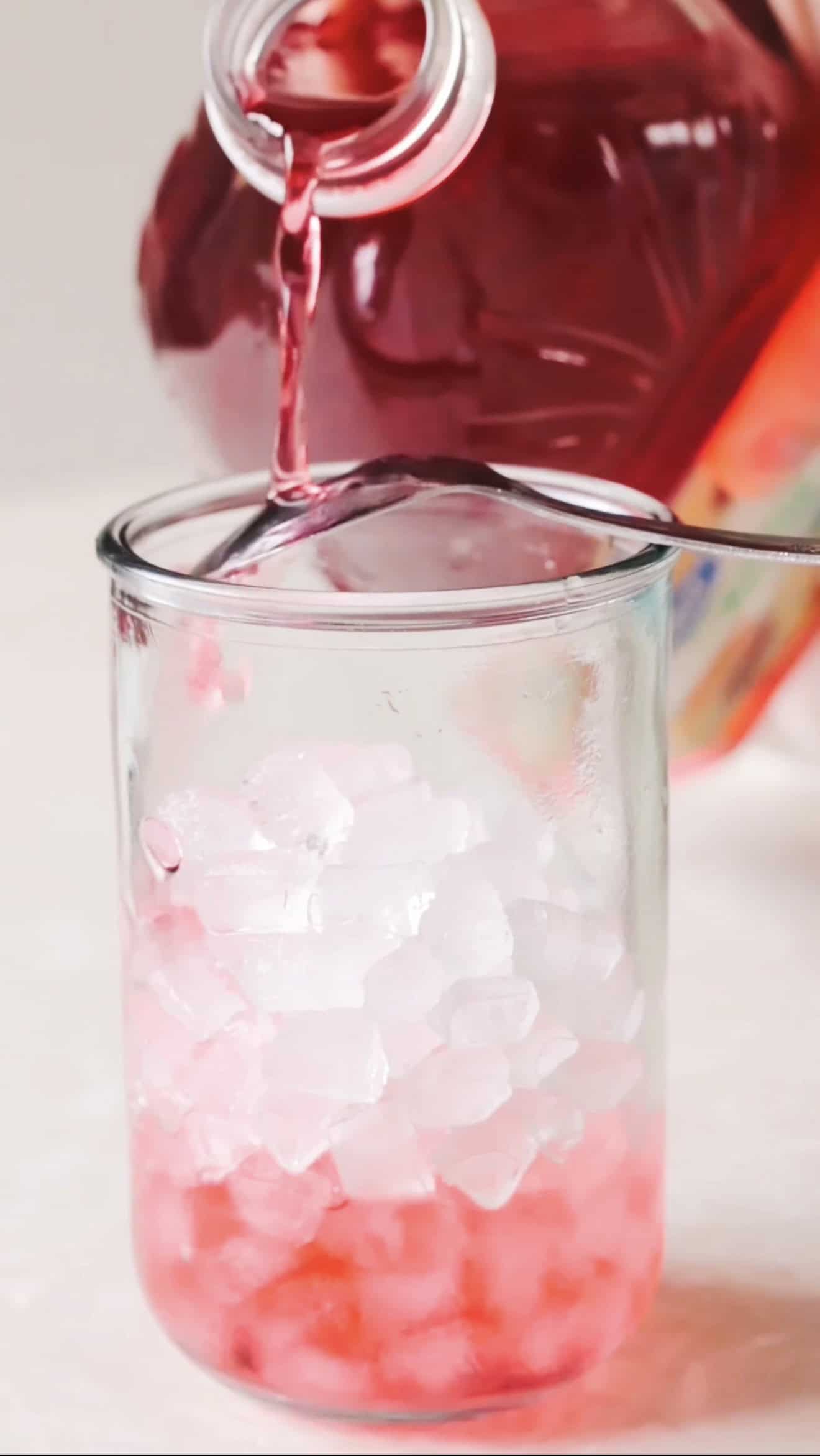 Cranberry juice poured over ice.