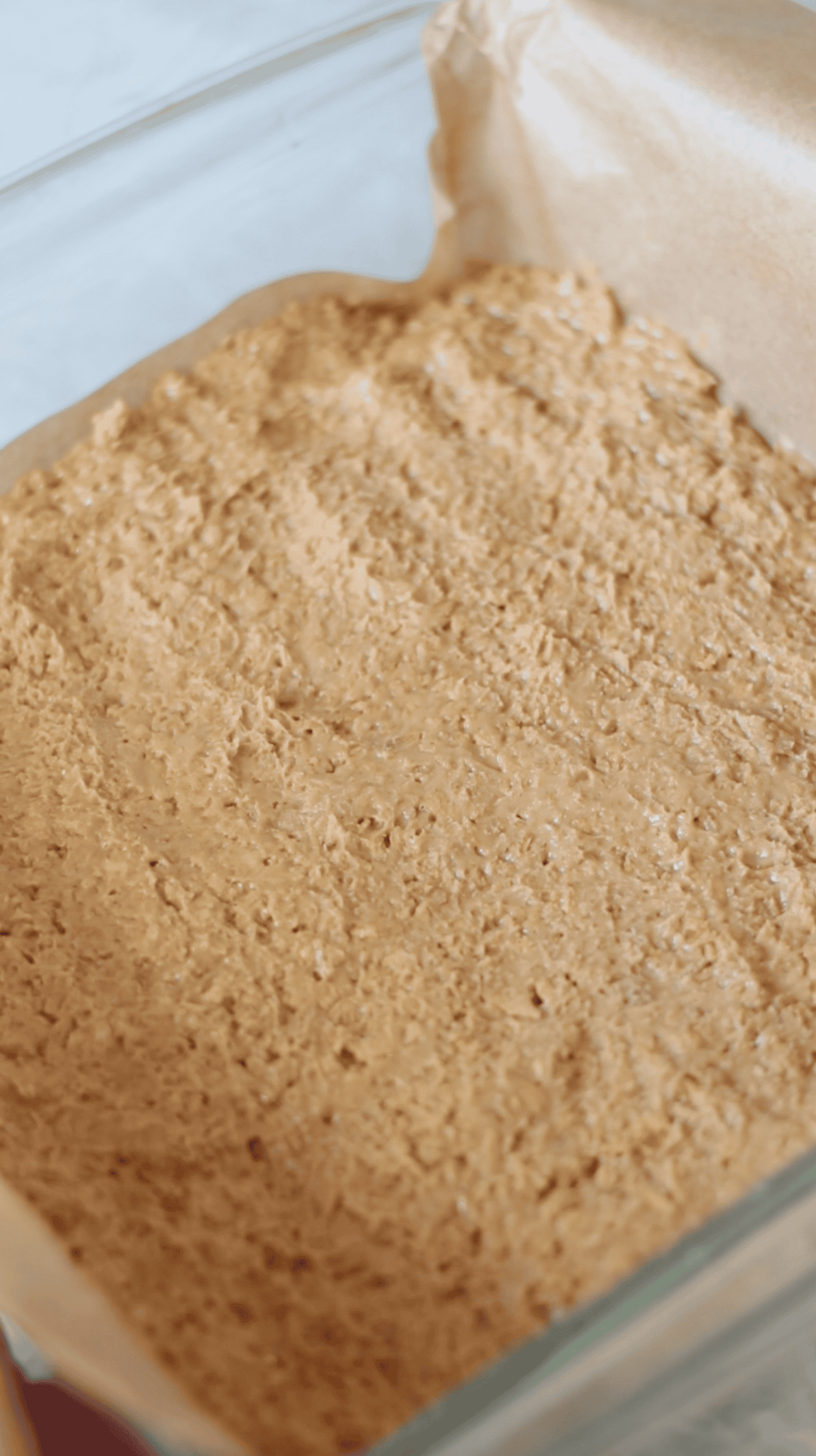 Butterfinger mixture pressed into baking dish.