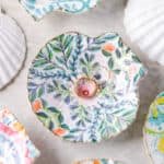 Decorated shell ring dish with gold rings.