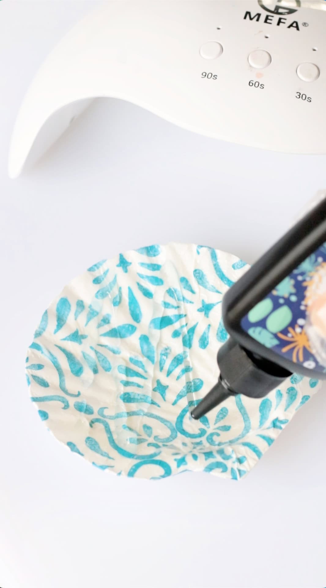 Resin drizzled over decorated scallop shell.