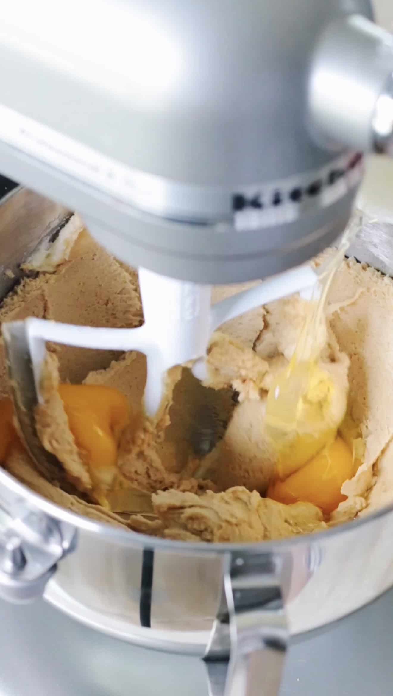 Stand mixer with butter, sugar and eggs mixing.