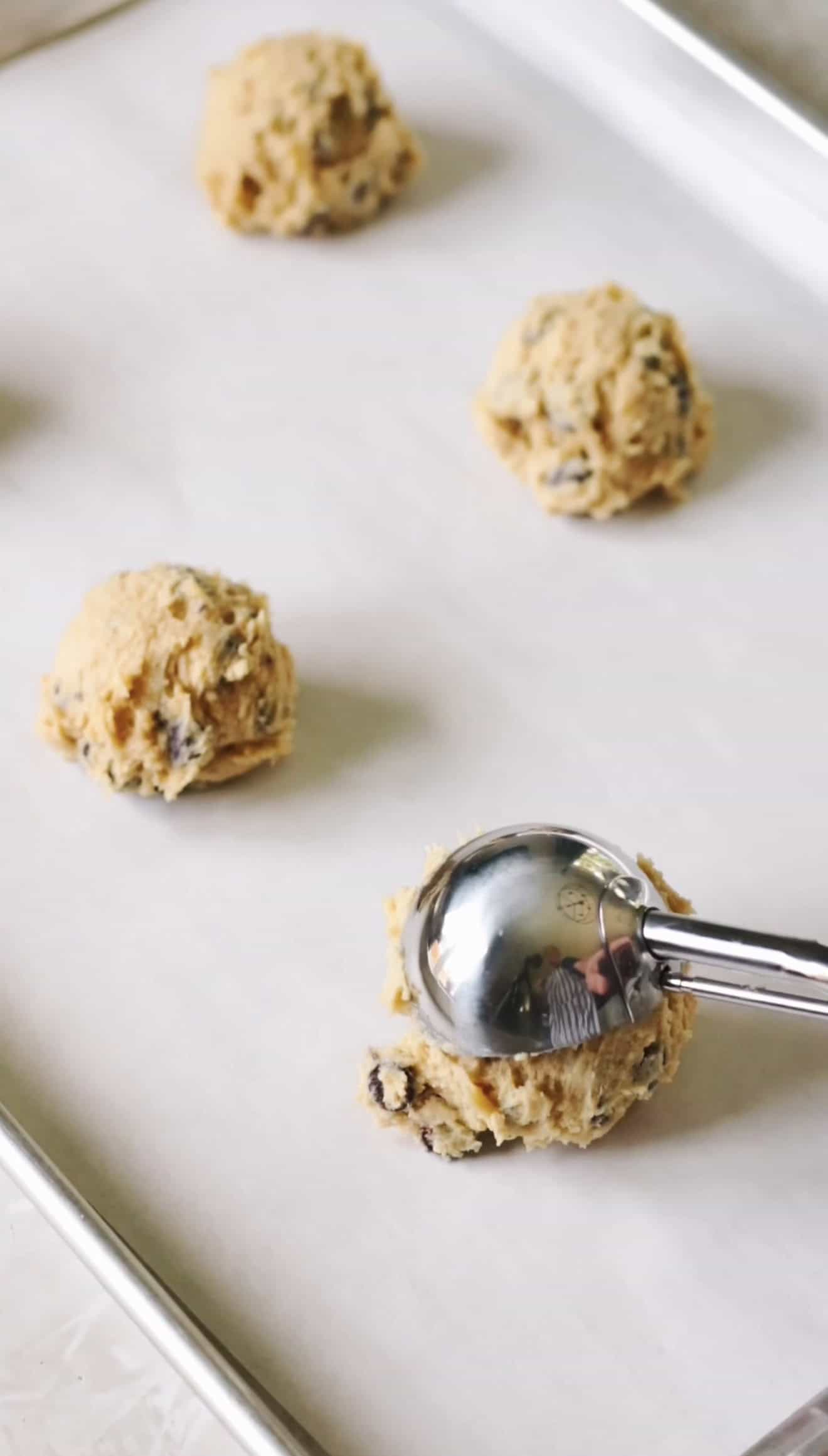 Scoops of cookie dough on baking sheet.