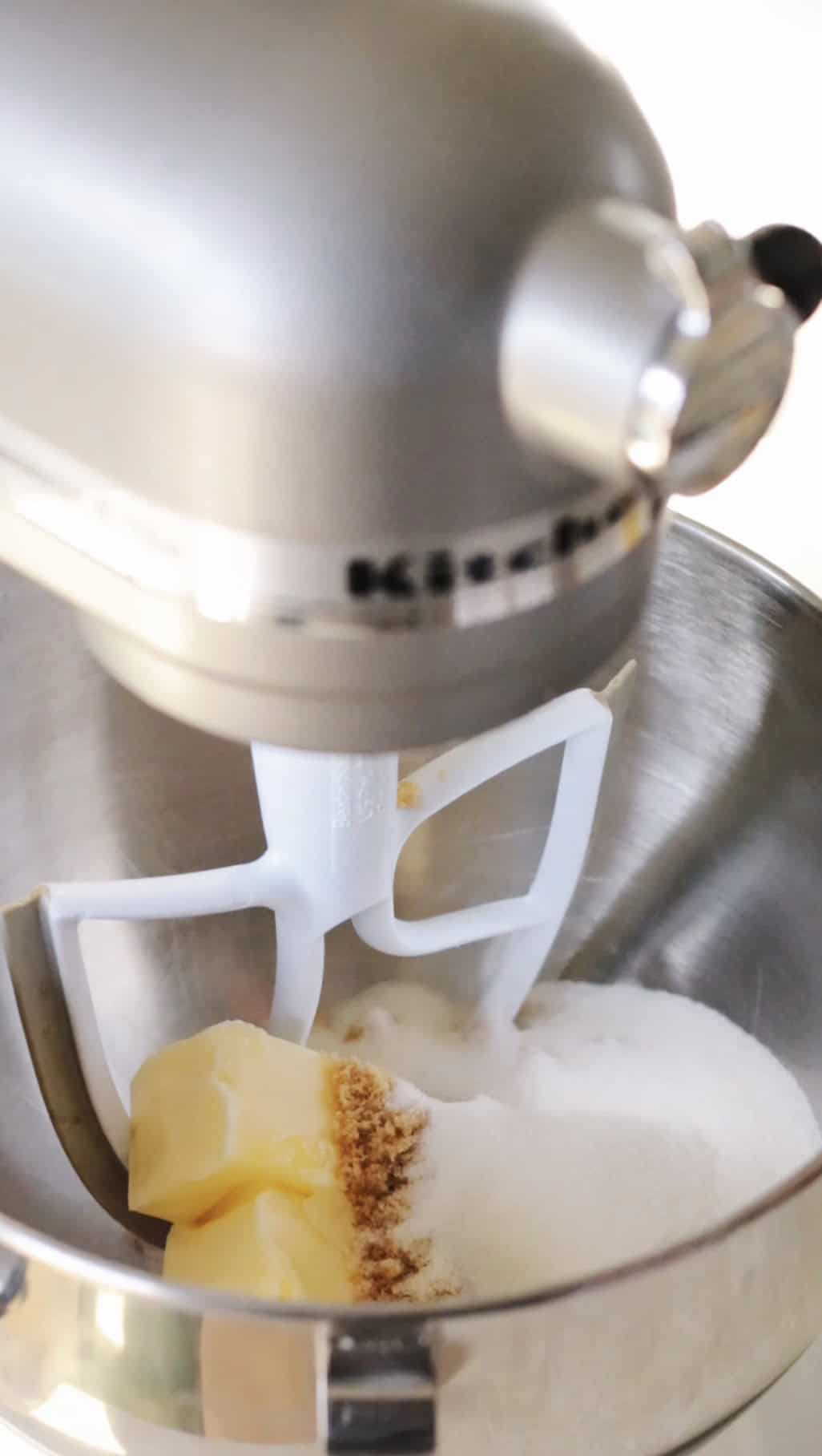 Stand mixer with sugar and butter mixture.