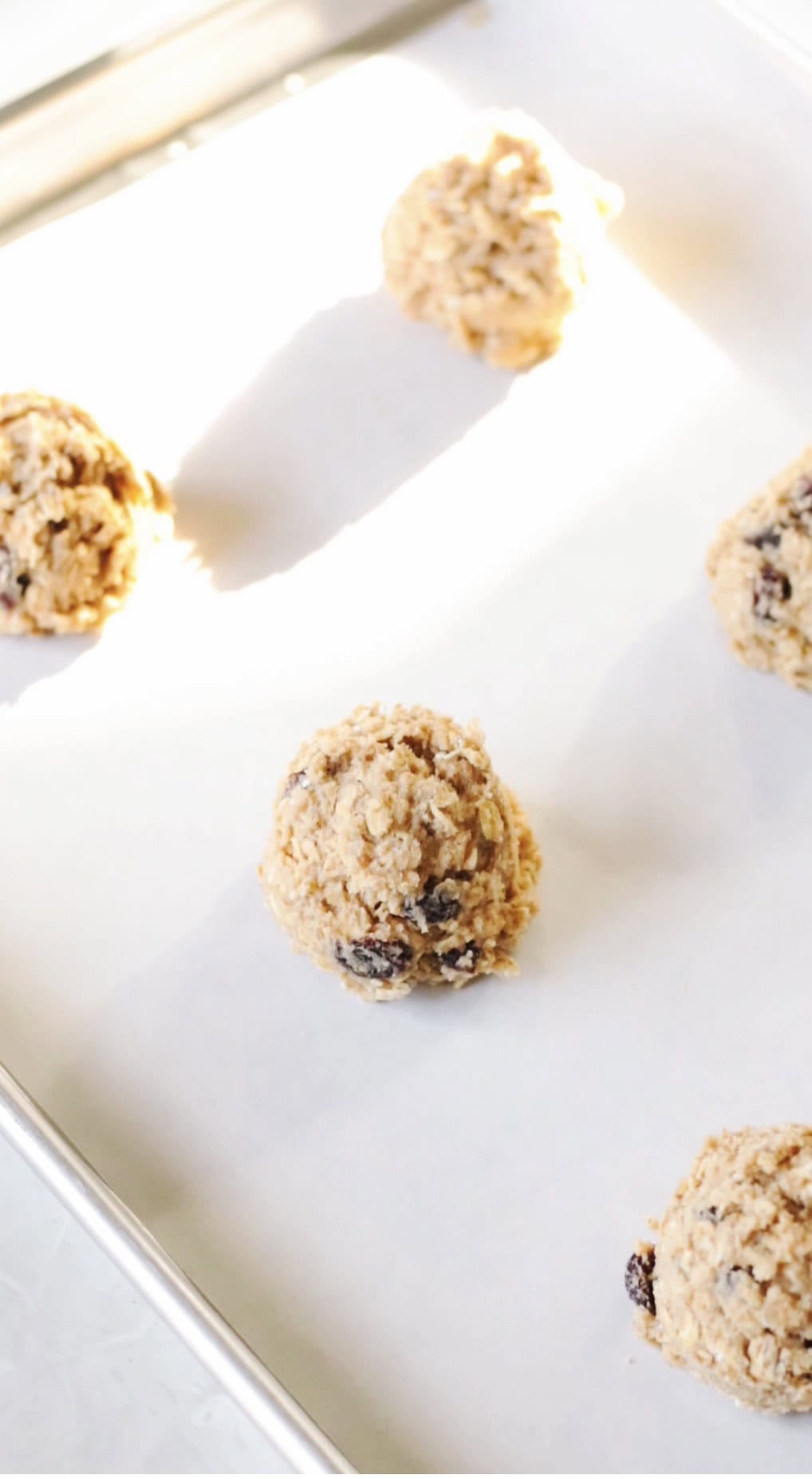 Oatmeal cookie dough balls on baking sheet.