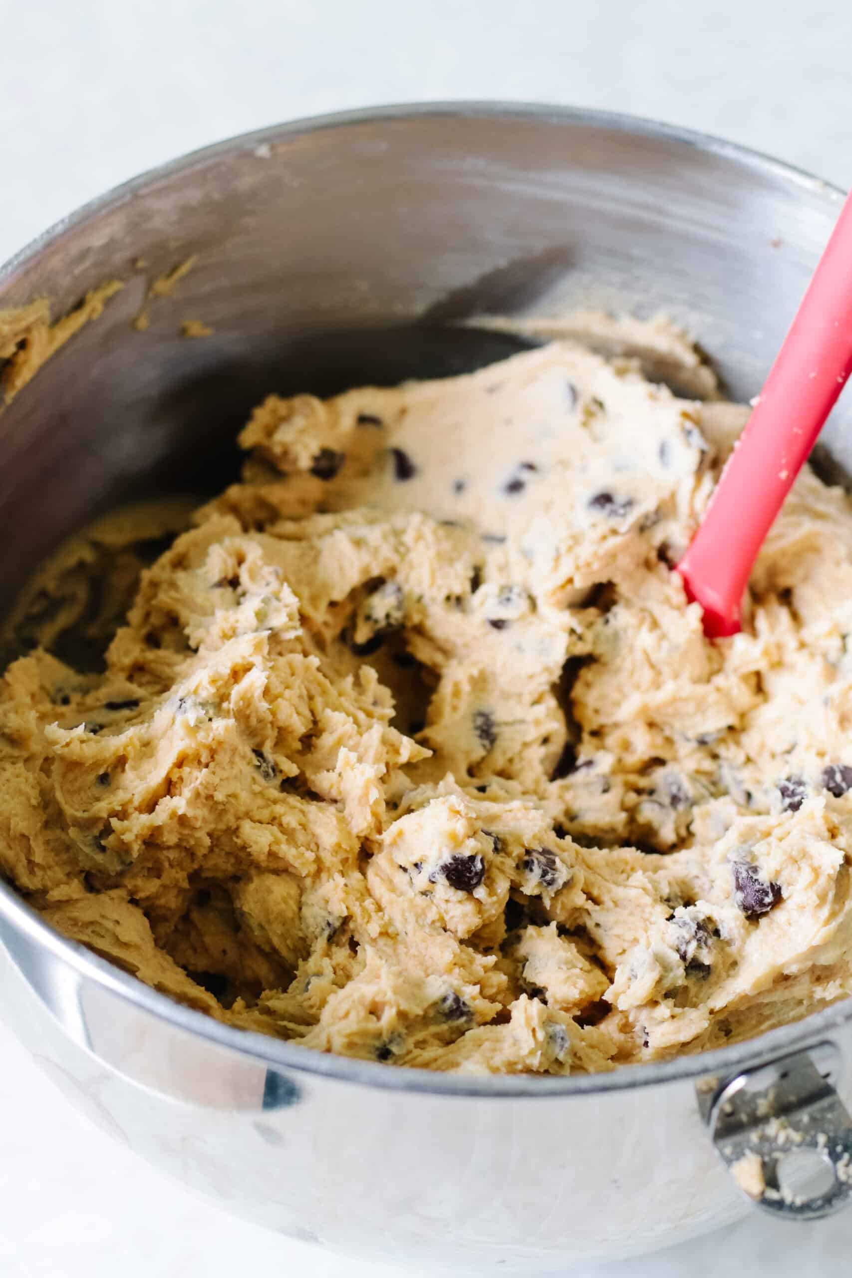 Metal mixing bowl of cookie dough.