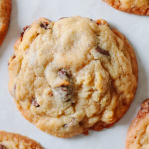 Chocolate chip cookie on parchment paper.