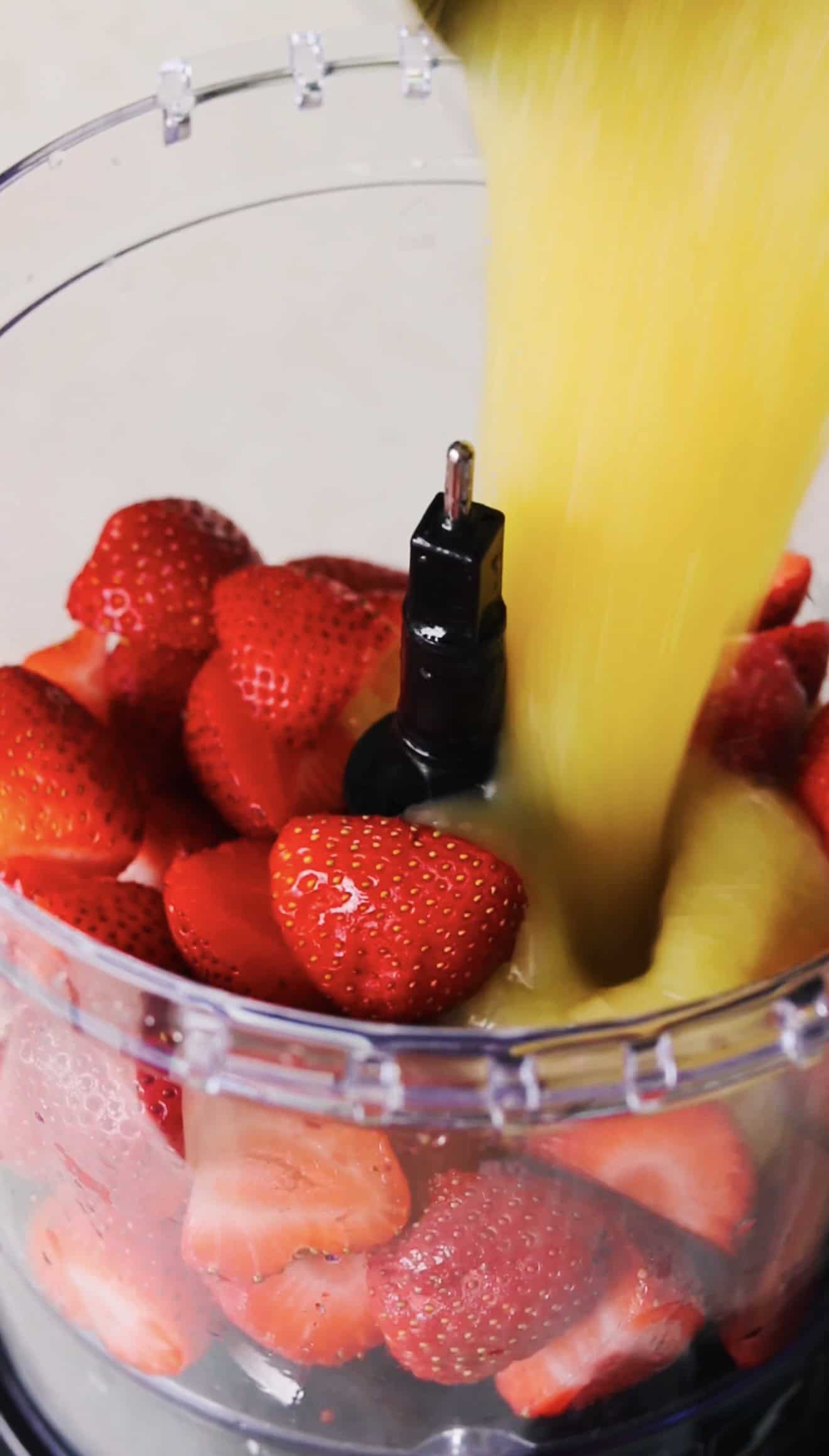 Food processor with strawberries and applesauce.