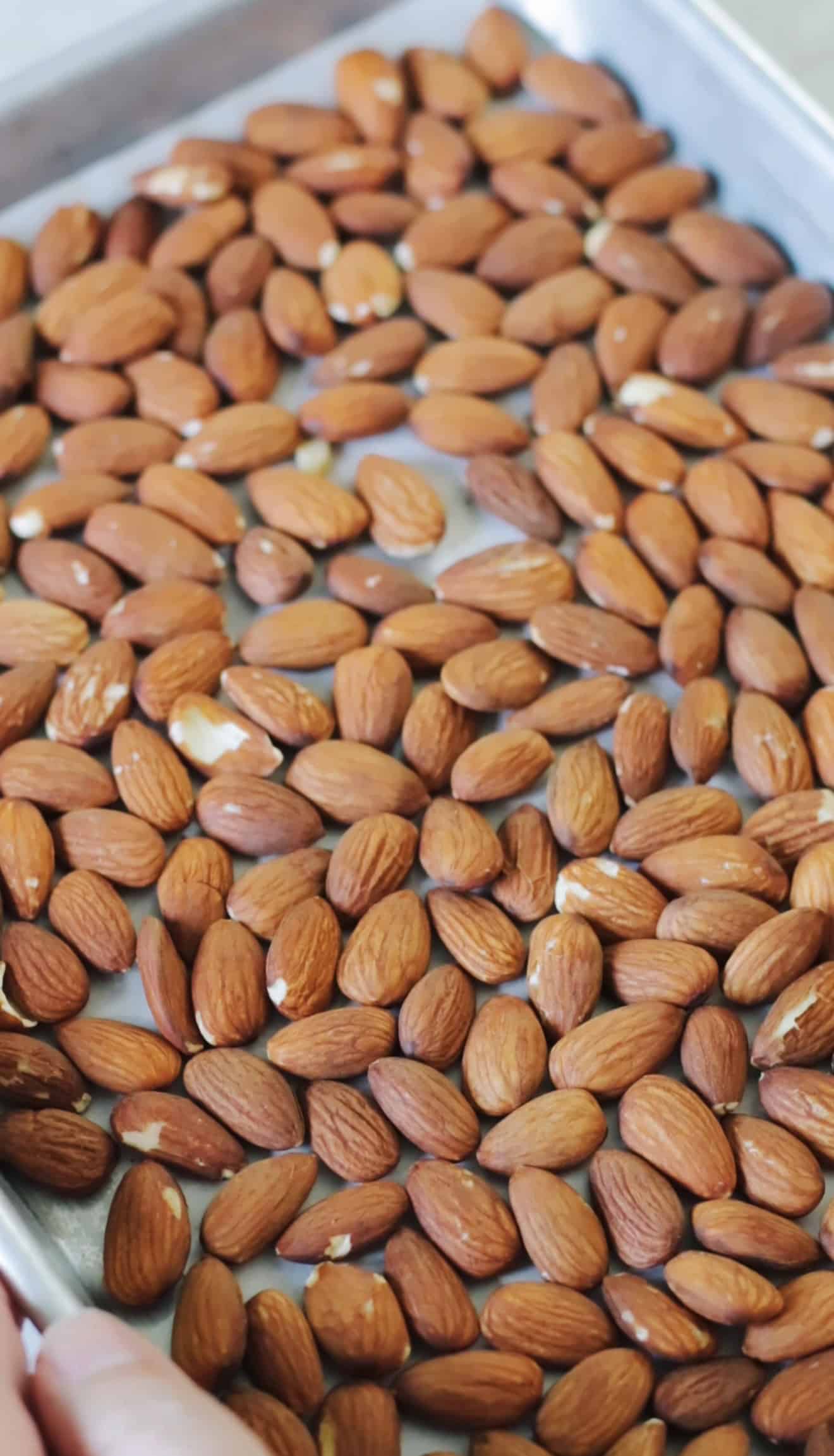 Whole almonds on baking sheet.