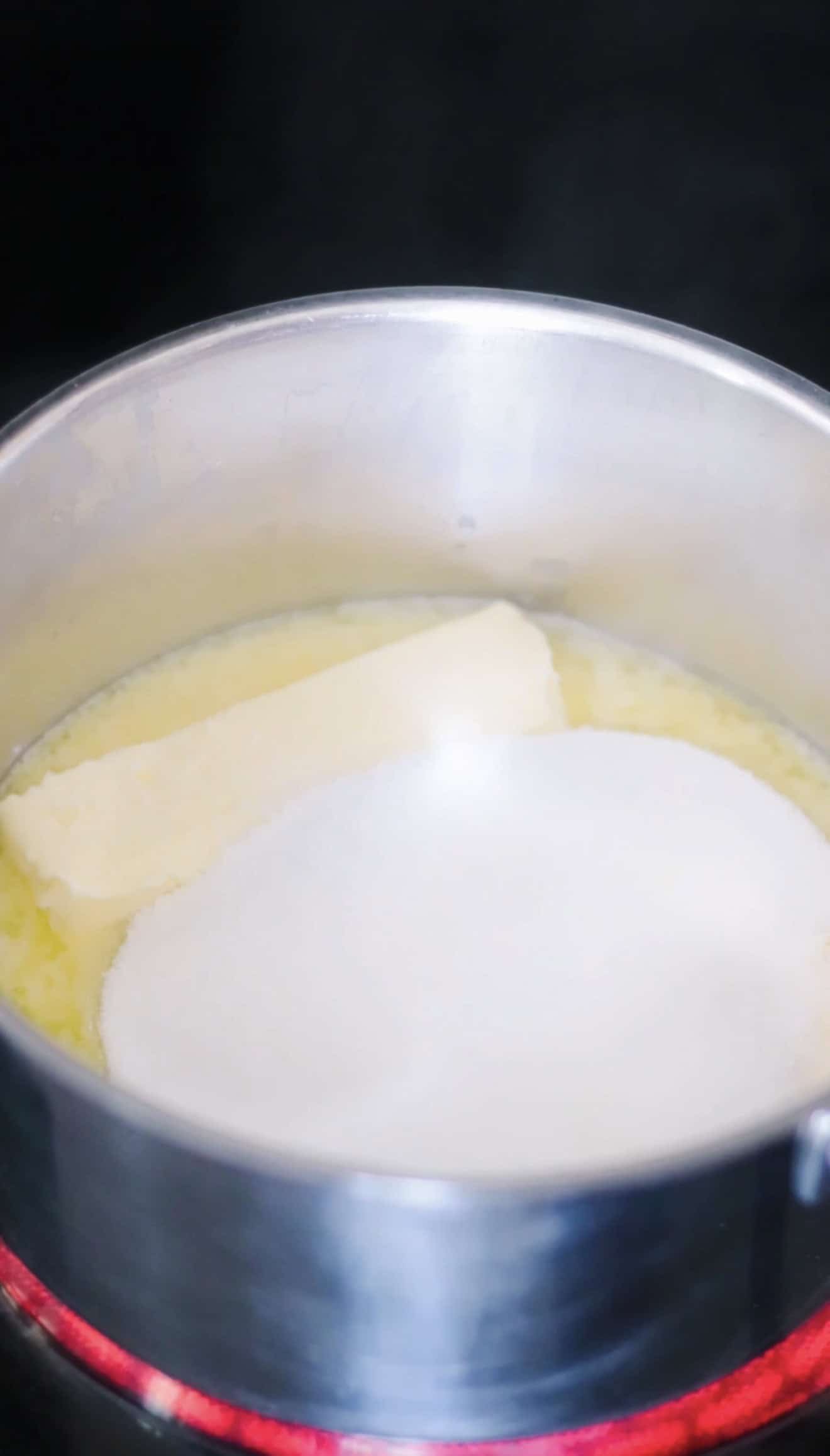 Saucepan with sticks of butter and sugar.
