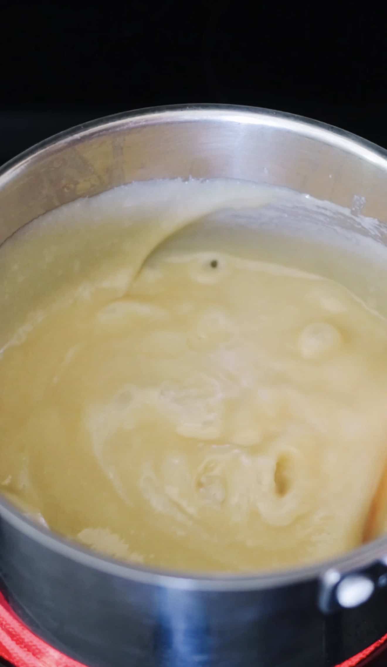 Hot toffee mixture cooking in pan.