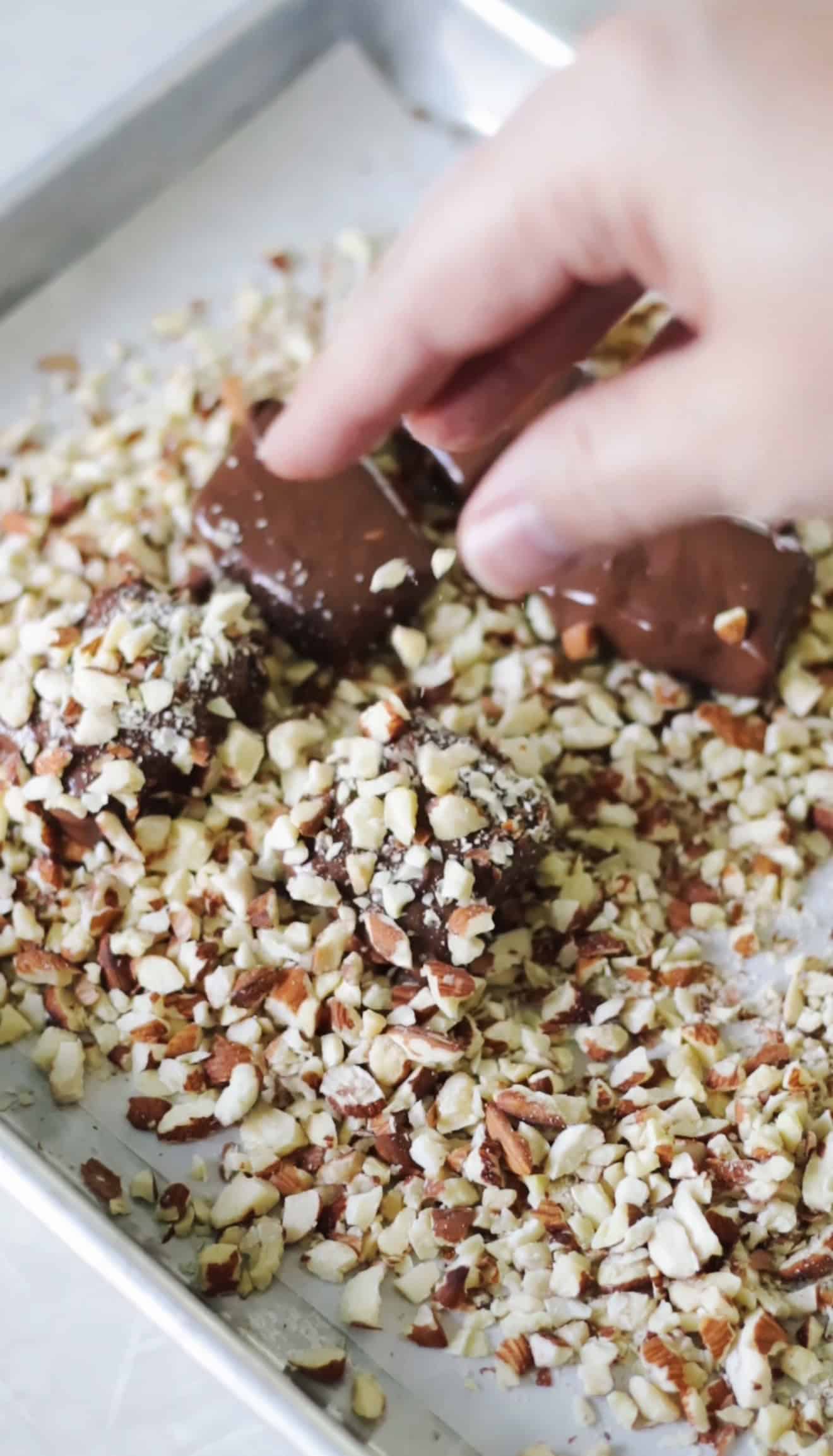 Chocolate coated pieces of toffee sprinkled with chopped almonds.