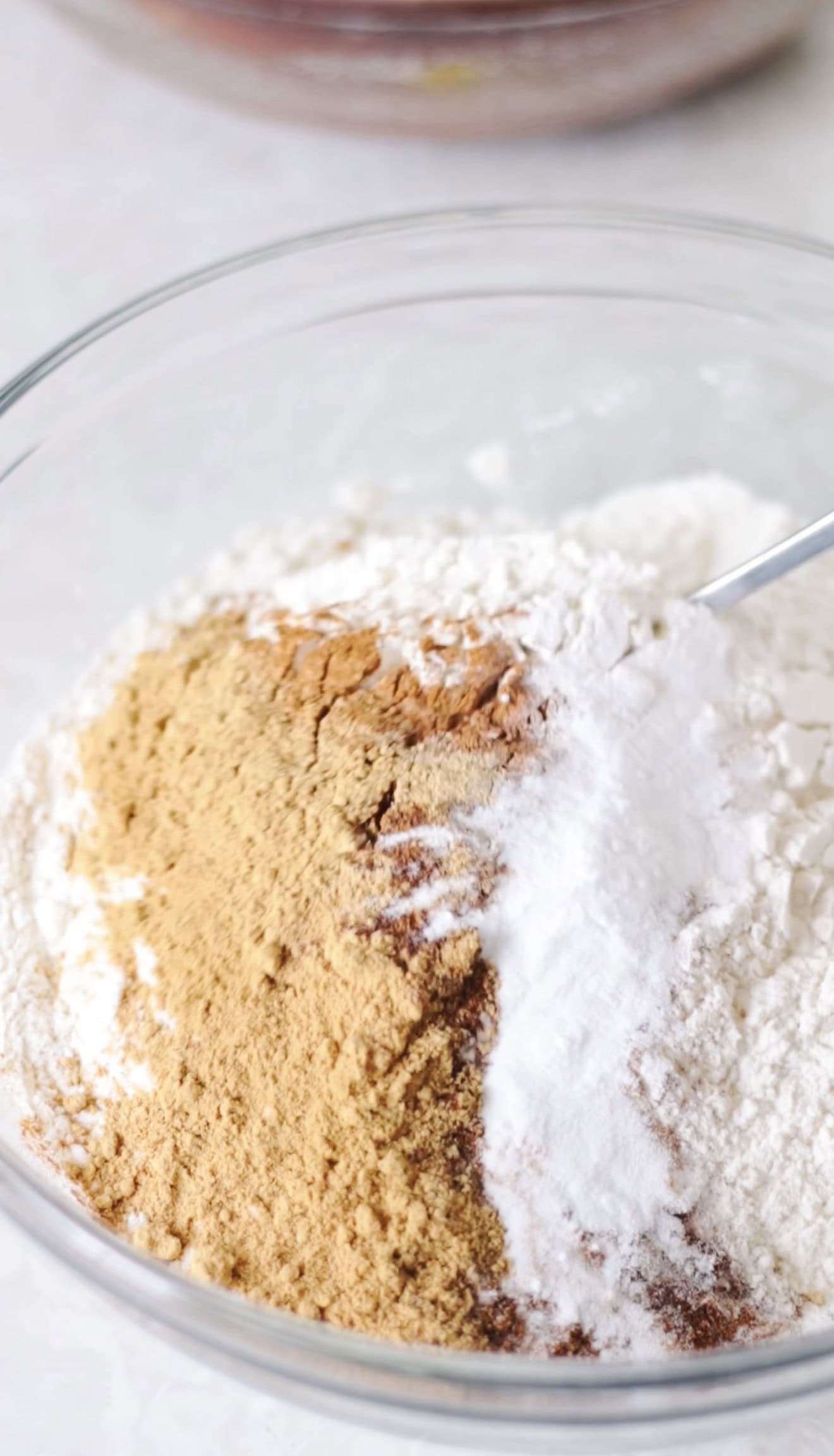 Flour and spices in glass mixing bowl.