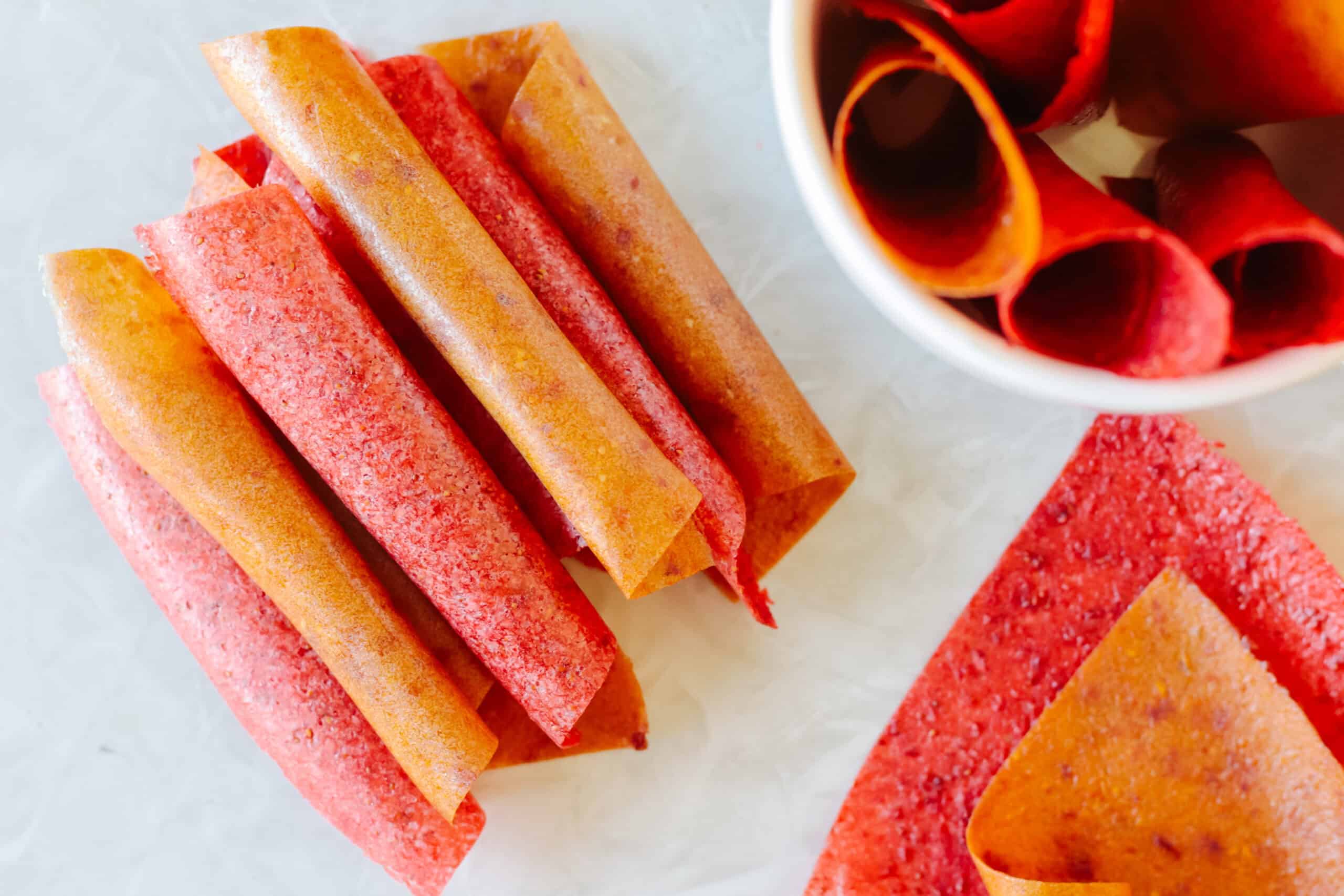 Rolls of peach and strawberry fruit leather.