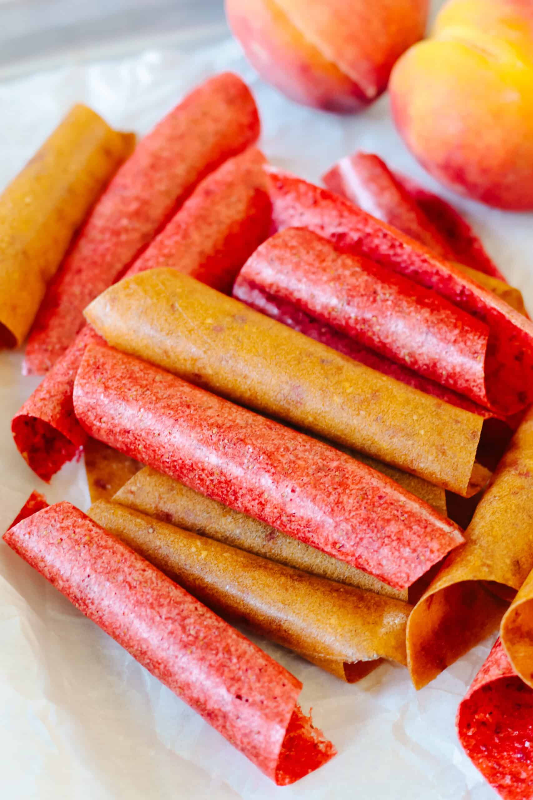 Rolls of homemade fruit leather on parchment paper.