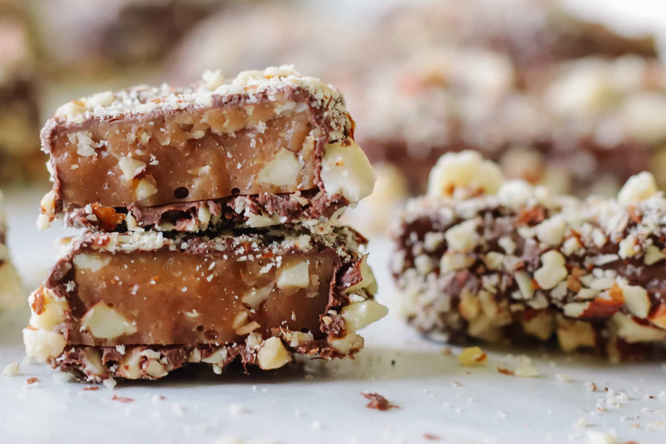 Almond roca broken in half and stacked.