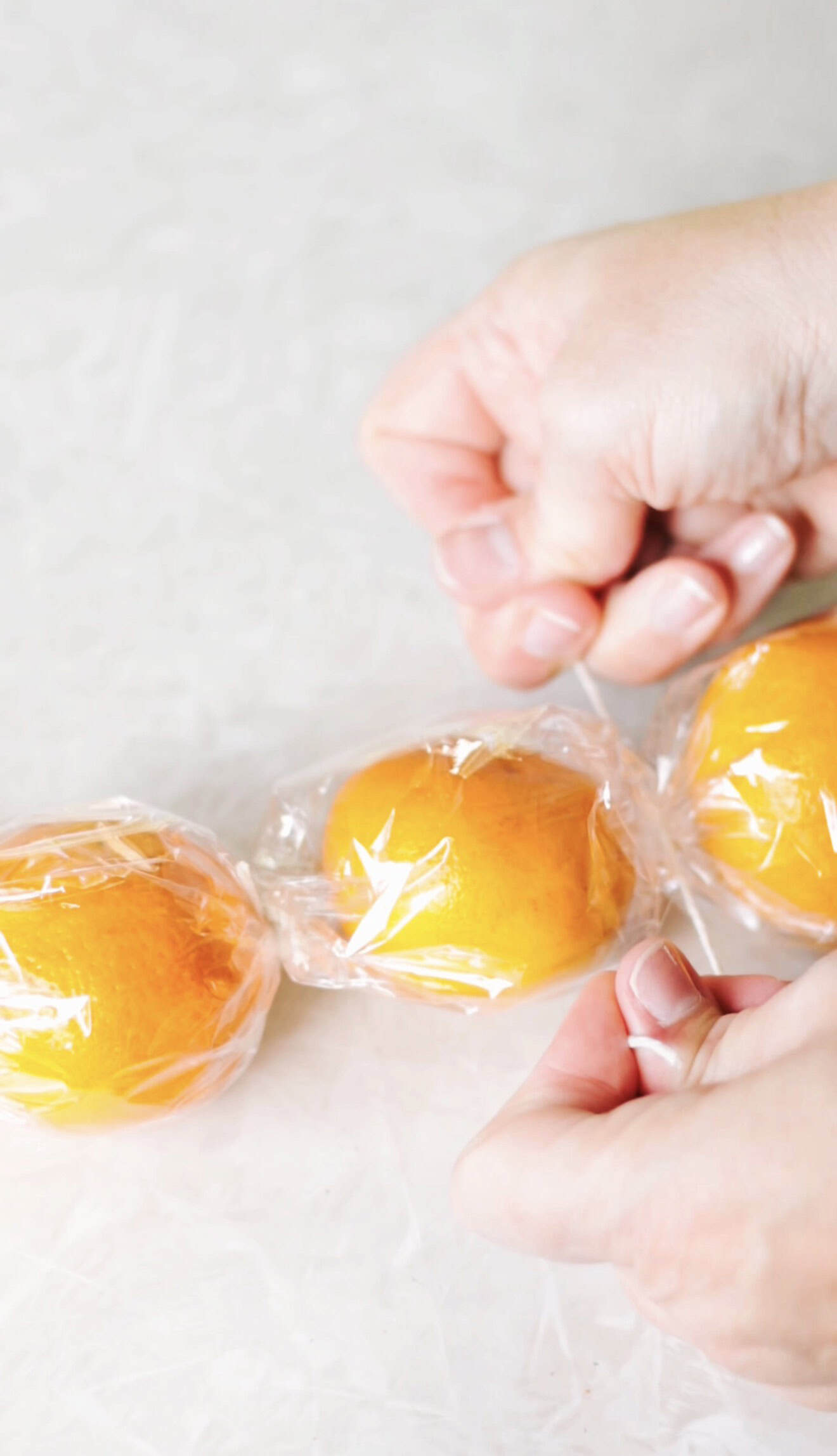 Hands tying cellophane with twine.