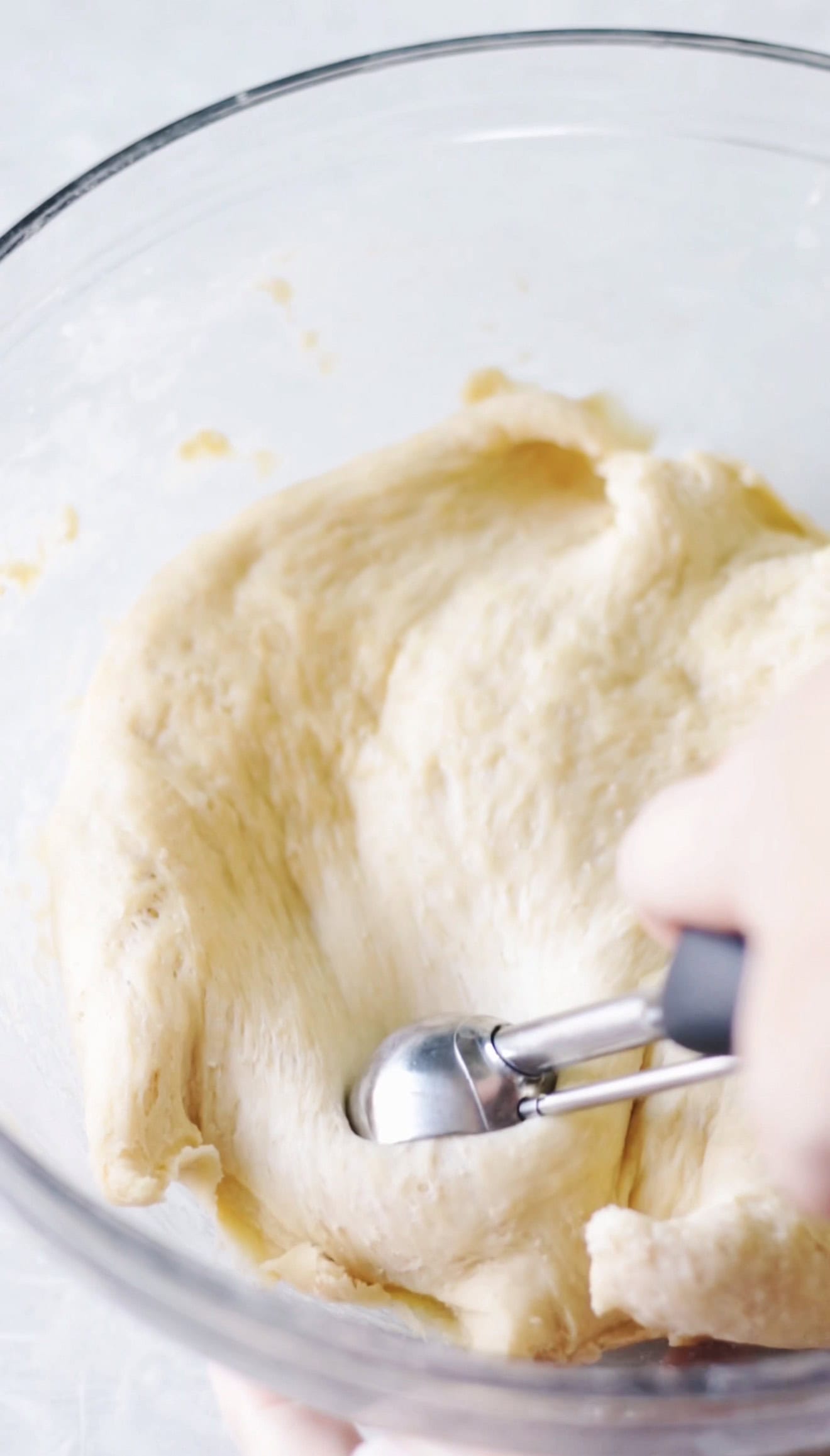 Glass bowl of bread dough.