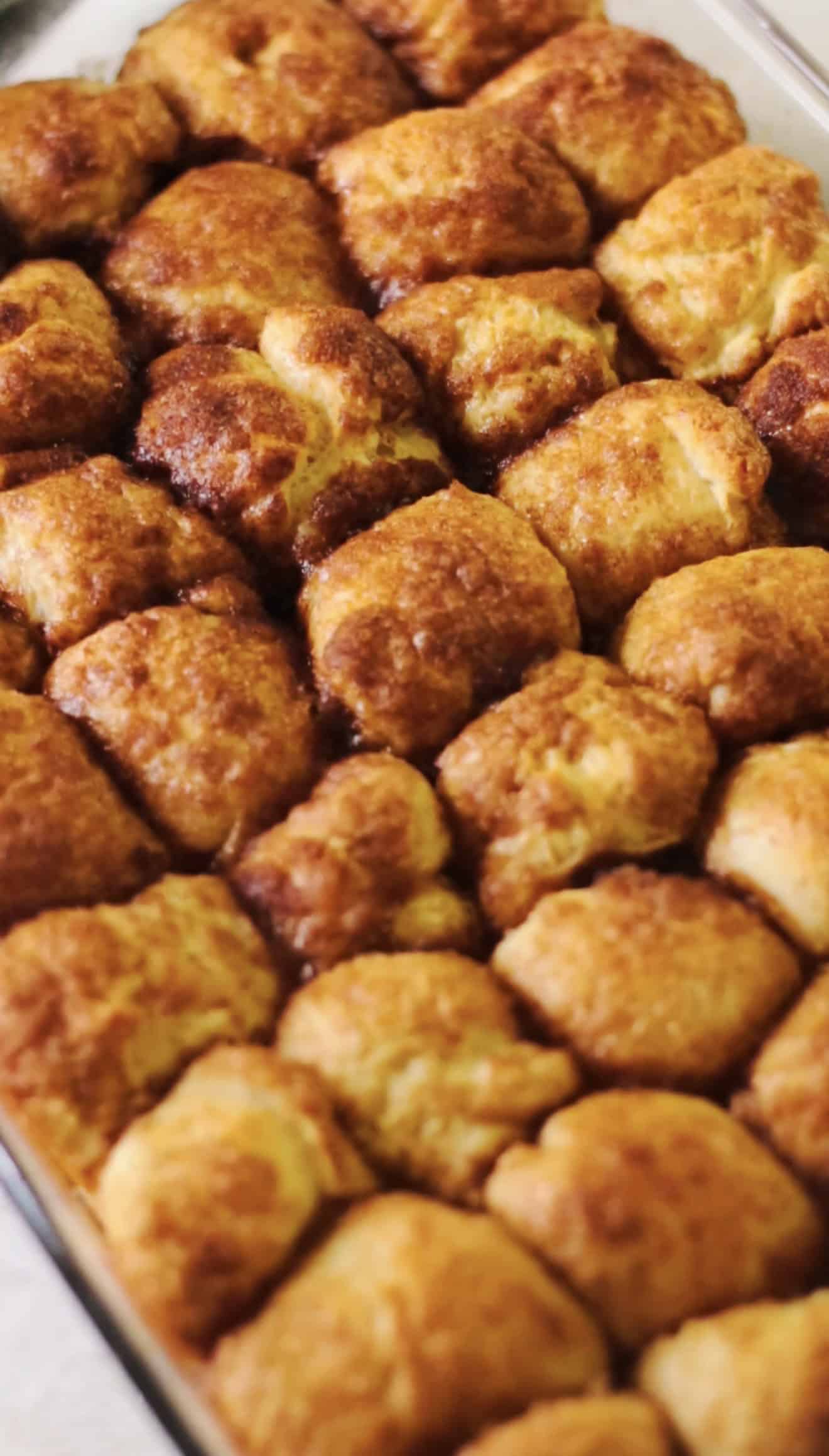 Unfrosted cinnamon roll bites in baking dish.