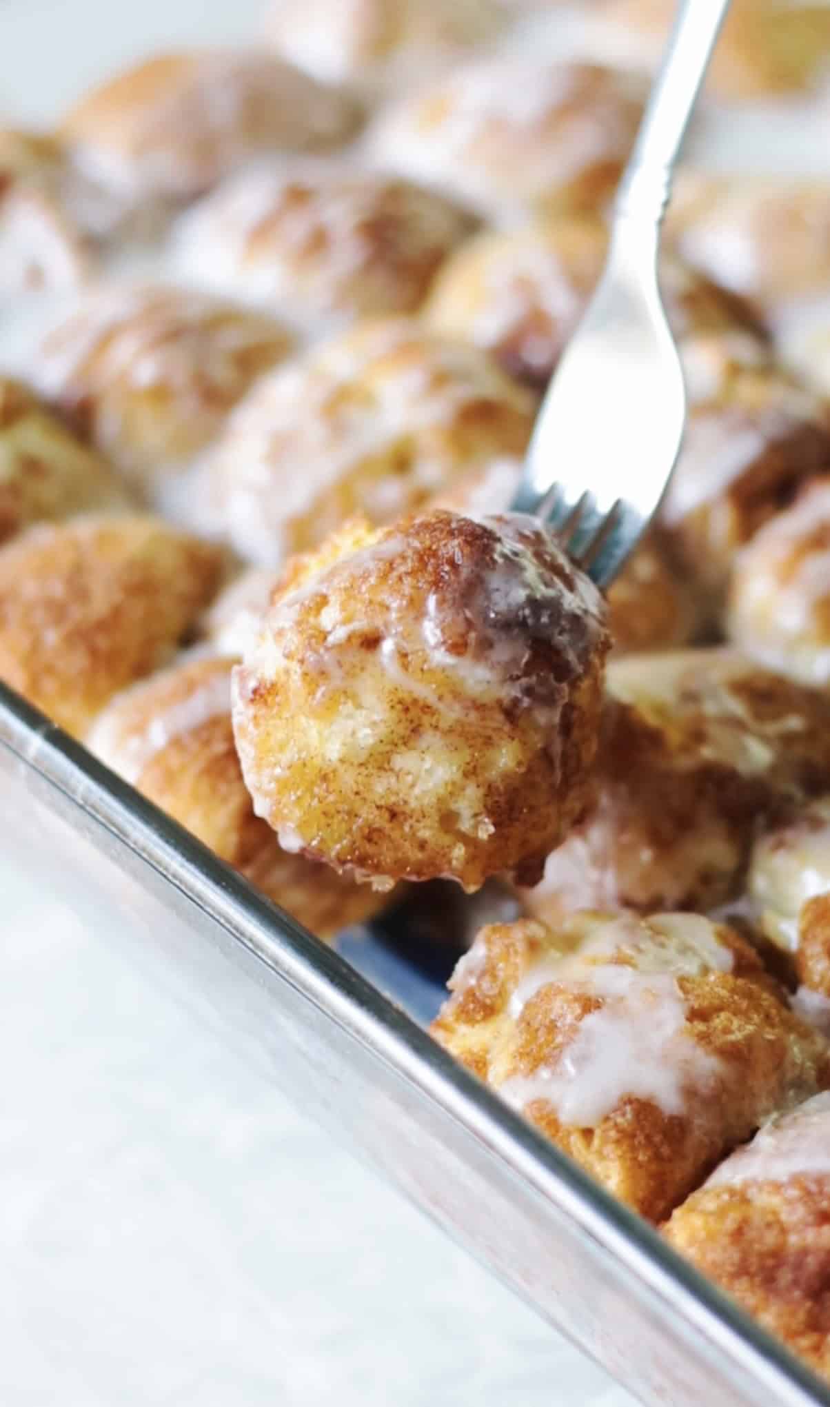 Cinnamon roll bite on fork.