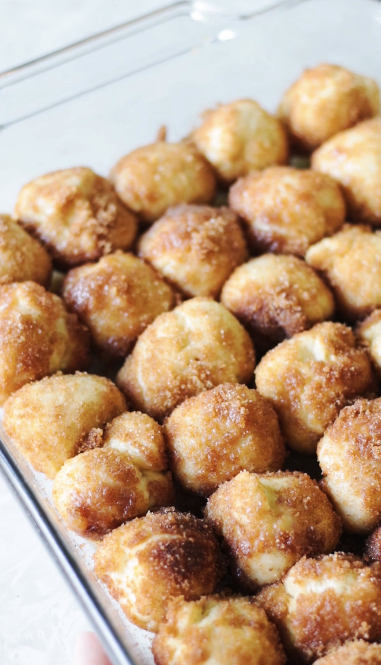 Unbaked cinnamon roll bites in baking dish.