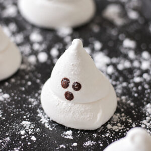 Ghost marshmallows on black platter.