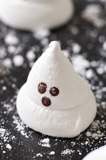 Ghost marshmallows on black platter.