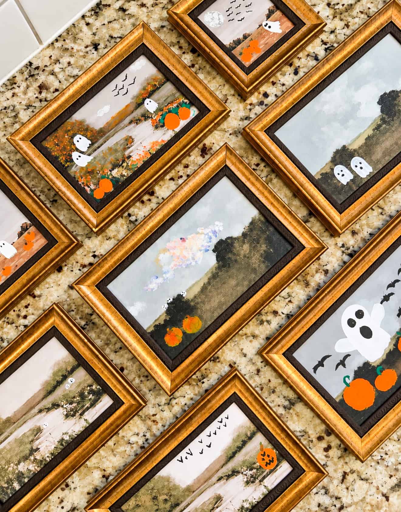 Frames of artwork with Halloween scenes painted on them.