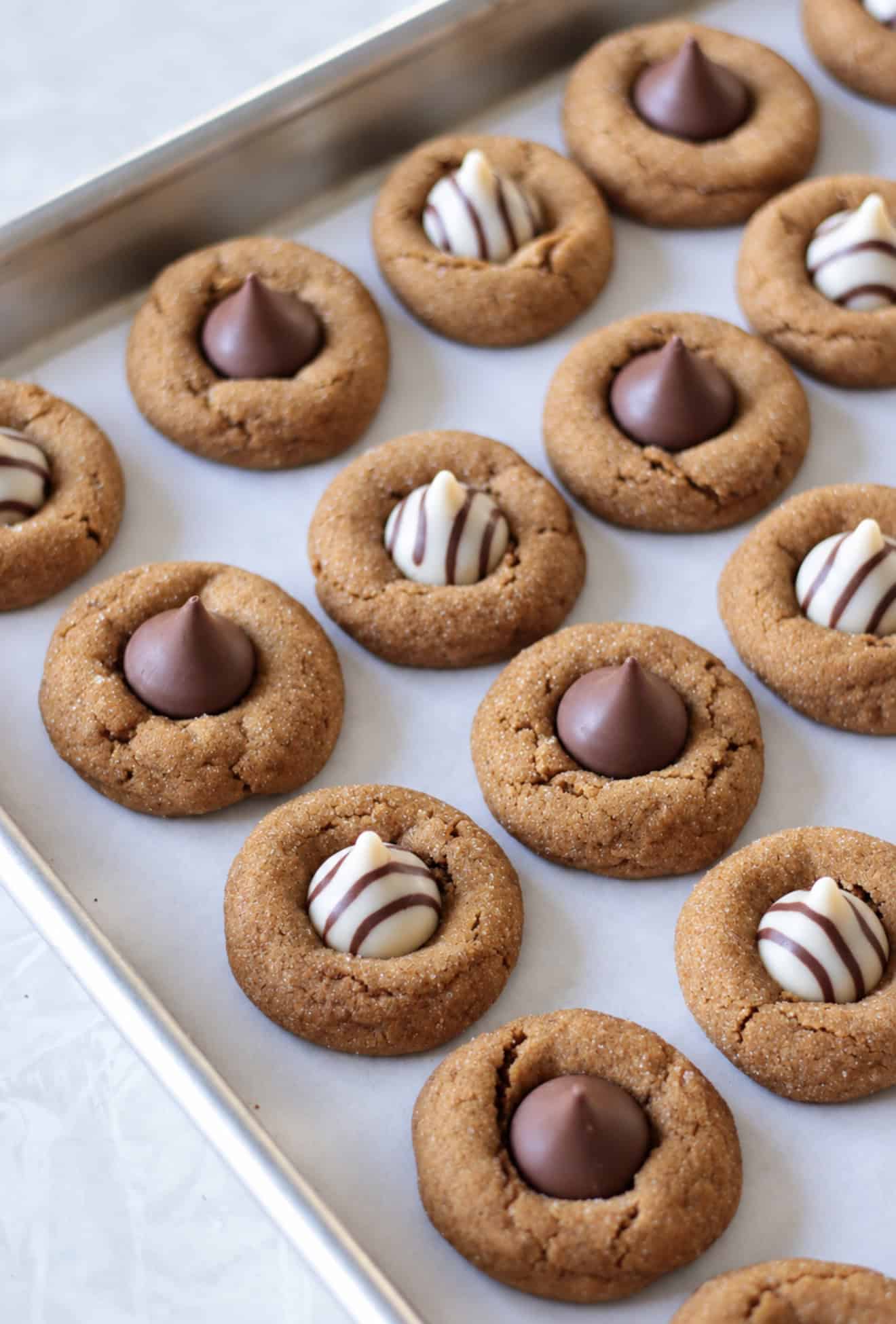 Baked blossom cookies on baking sheet.