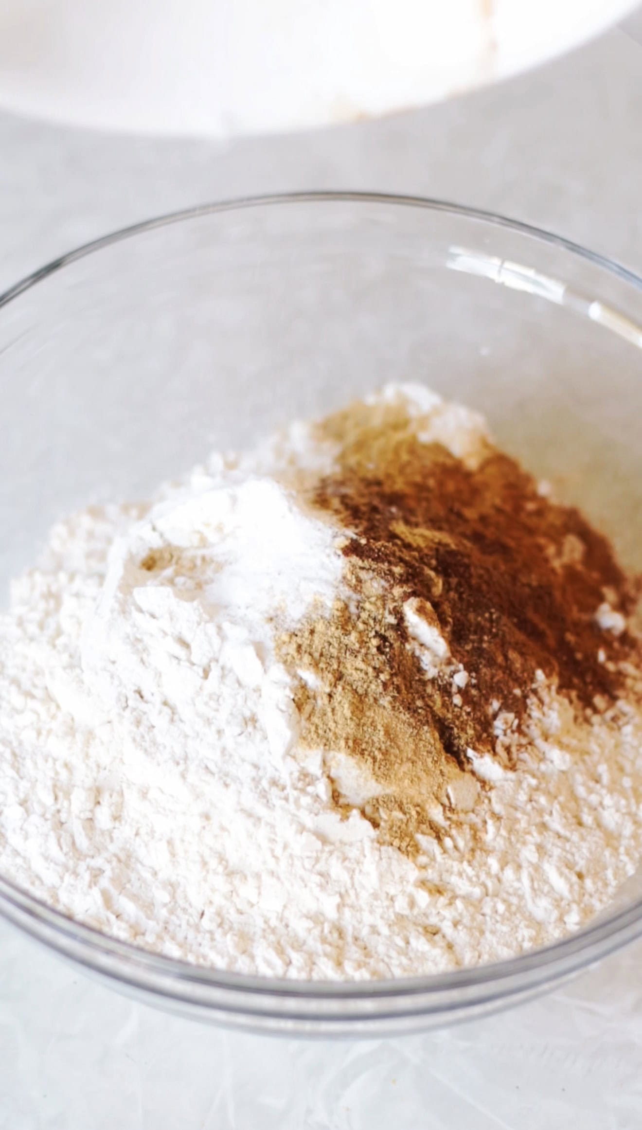 Glass bowl with flour, spices, salt and baking soda.