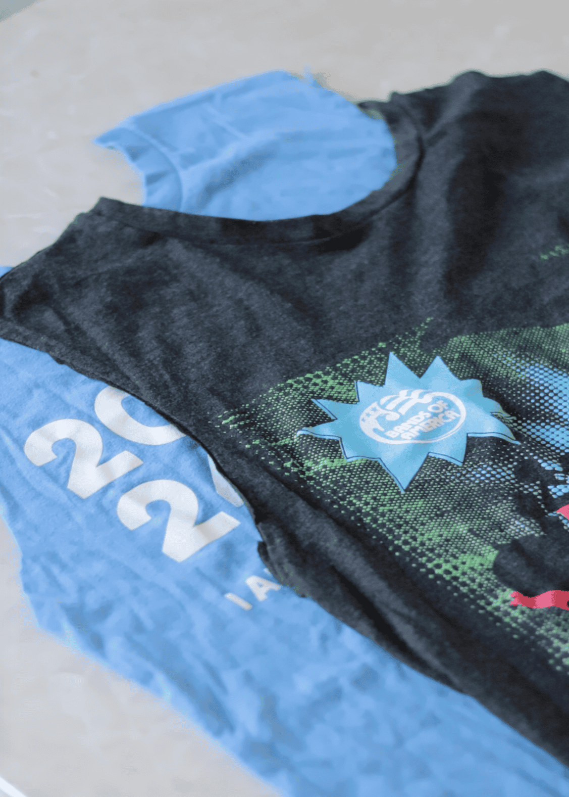 Two t-shirts cut up the sides and sleeves removed.