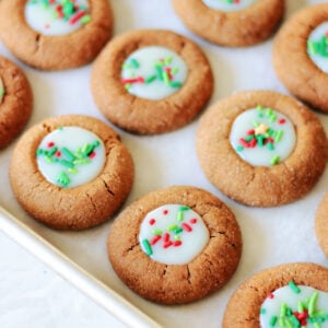 Gingerbread thumbprints on baking sheet.