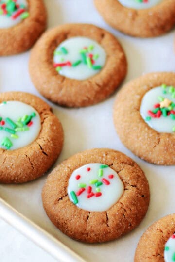 Gingerbread thumbprints on baking sheet.