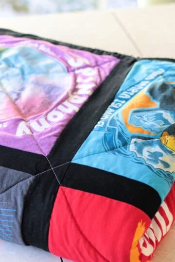 Finished quilt folded on table.