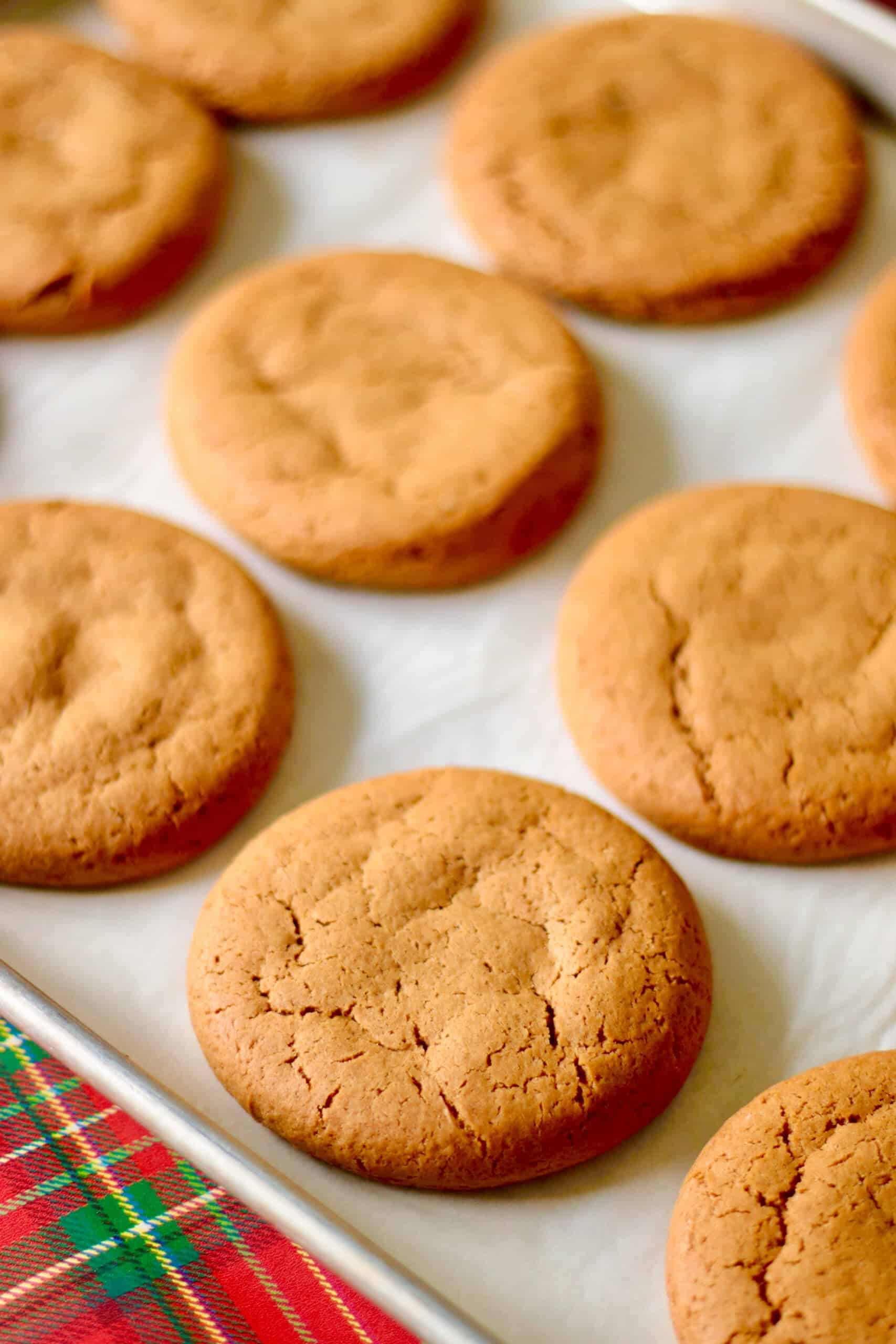 Baking sheet with baked gingerbread cookies on it.
