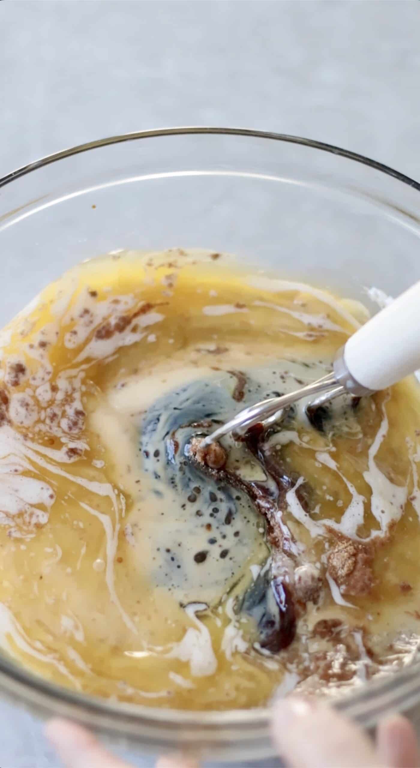 Mixing bowl of melted butter, sugar, spices, and molasses.